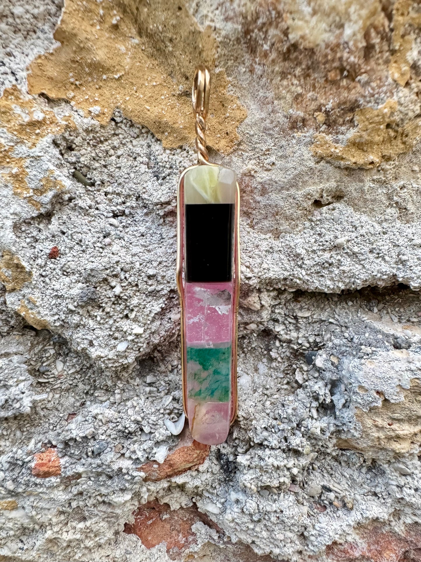 Multicolored pendant on a stone surface